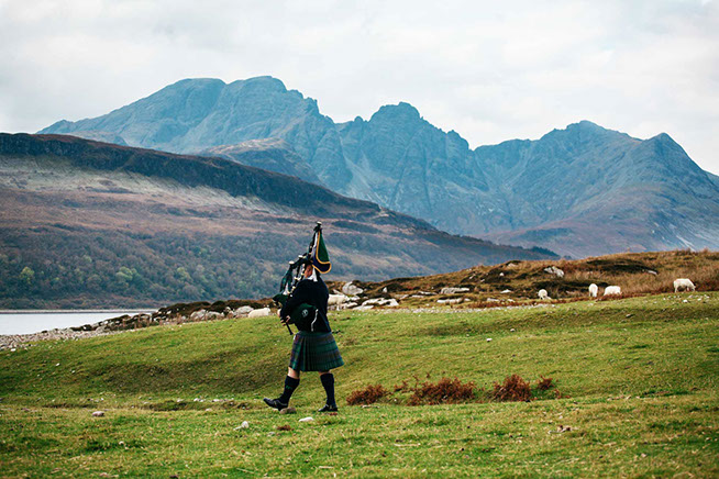 Alistair Ally K Macpherson playing beside the Cuillin Mountain Range on the Isle of Skye in Scotland 